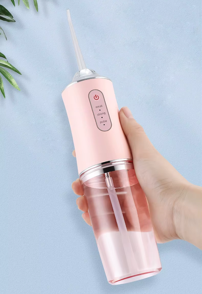 Ірригатор для порожнини рота ORAL IRRIGATOR 3 режими з насадками рожевий eve1283 фото